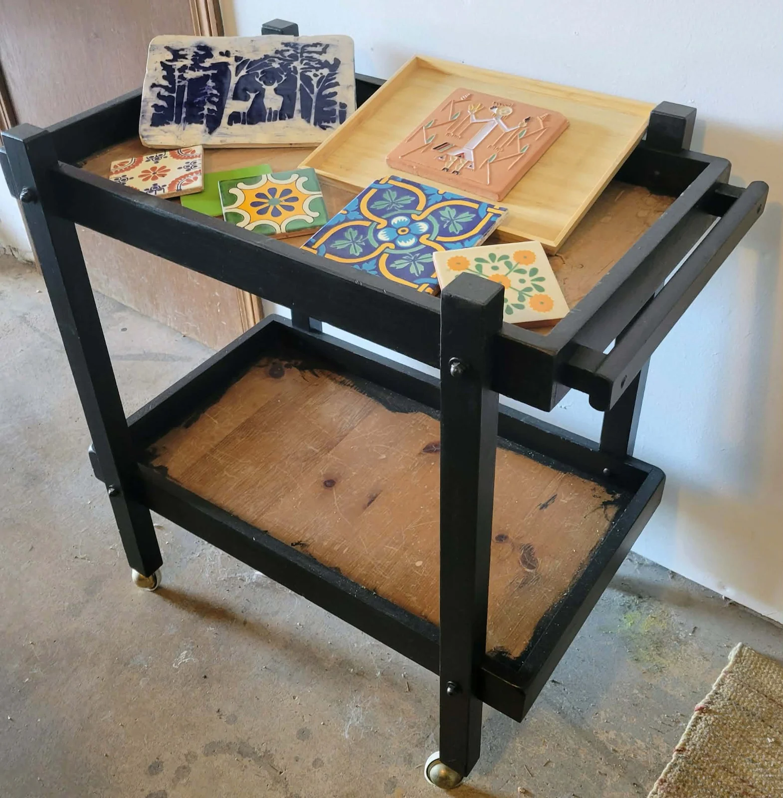 Found furniture and colorful ceramic tiles gathered for a mosaic.